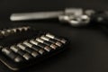 357 Caliber hollow point bullets near revolver pistol gun on black background Royalty Free Stock Photo