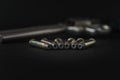 357 Caliber hollow point bullets near revolver pistol gun on black background Royalty Free Stock Photo