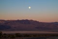 California desert with full moon at early morning right before sunrise, Death Valley, USA Royalty Free Stock Photo