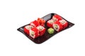 California Maki Sushi roll with Masago and salmon on black plate isolated on white background Royalty Free Stock Photo