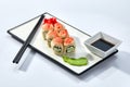 California or Philadelphia sushi rolls set served on a white tray over white background. Japanese cuisine concept Royalty Free Stock Photo