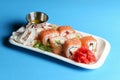 California or Philadelphia sushi rolls set served on a white tray over blue background. Japanese cuisine concept Royalty Free Stock Photo