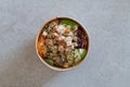 California Poke Bowl with salmon, avocado, crab surimi, carrot, red cabbage, ginger, sushi rice and cucumber