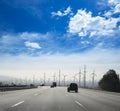 California road with electric windmills aerogenerators Royalty Free Stock Photo