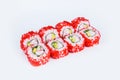 California roll wrapped in rice and red flying fish roe Tobiko caviar served on gray background with snow crab meat crab sticks Royalty Free Stock Photo