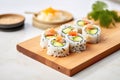 california rolls with crabmeat and cucumber on a wooden board