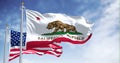 The California state flag waving along with the national flag of the United States of America Royalty Free Stock Photo