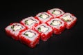 California sushi roll with Philadelphia cheese, crab with masago caviar on a black background. Royalty Free Stock Photo