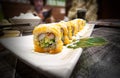 California sushi rolls on a white square plate on a table Royalty Free Stock Photo