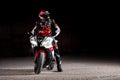15.10.20, California, USA. The driver in a motorcycle jacket and helmet sits on a sportsbike. Black background. Copy space