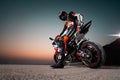 15.10.20, California, USA. The driver in a motorcycle jacket and helmet is sitting on a sportbike, looking back. Rear view