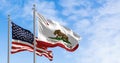 California and USA flags waving on a clear day Royalty Free Stock Photo