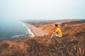 Young man exploring California by the ocean at Point Reyes cliffs. Royalty Free Stock Photo