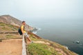 Young man exploring California by the ocean at Point Reyes cliffs. Royalty Free Stock Photo