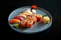 Californian sushi roll set with salmon in tobiko caviar and various sushi. Sushi with salmon, tuna, shrimp. Japanese rolls served Royalty Free Stock Photo