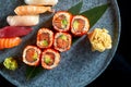 Californian sushi roll set with salmon in tobiko caviar and various sushi. Sushi with salmon, tuna, shrimp. Japanese rolls served Royalty Free Stock Photo