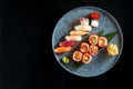 Californian sushi roll set with salmon in tobiko caviar and various sushi. Sushi with salmon, tuna, shrimp. Japanese rolls served Royalty Free Stock Photo