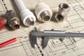 Engineer workspace concept. caliper, calipers, plumbing and flanges on the drawing Royalty Free Stock Photo