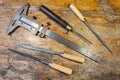 Caliper, files and pricker on a table in a workshop