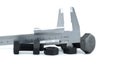 Caliper measuring a metal nut, illustrating precision engineering and industrial tools on a white Royalty Free Stock Photo