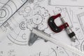 Caliper, micrometer and engineering drawings of industrial parts