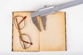 Caliper and old book with glasses on a white table. Workshop accessories Royalty Free Stock Photo
