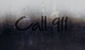 Call 911 alert message written on car or building window
