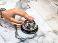 Call bell in restaurant vintage with hand service granite background luxury. Royalty Free Stock Photo