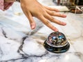 Call bell in restaurant vintage with hand service granite background luxury. Royalty Free Stock Photo