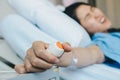 Patient woman trying to pressing emergency button in hospital ward for calling nurse or health care staff. Royalty Free Stock Photo