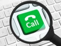 Call button under the magnifying glass Royalty Free Stock Photo