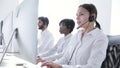 Call Center Agents Consulting Clients On Hotline At Office