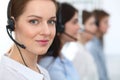 Call center. Beautiful cheerful smiling operator consulting clients with headset. Business concept of customer service