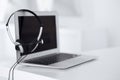Call center and communication support, customer service help desk. VOIP headset on laptop computer Royalty Free Stock Photo