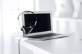 Call center and communication support, customer service help desk. VOIP headset on laptop computer Royalty Free Stock Photo