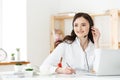 Call Center Concept: Portrait of happy smiling female customer support phone operator at workplace. Royalty Free Stock Photo