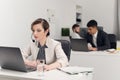 A call center employee sits at a Desk in the office of a large financial company in a strict office dress code.