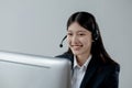 Call center employee talking with customer through headset, The operator is providing customer service by phone, Customer service Royalty Free Stock Photo