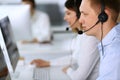 Call center. Group of diverse operators at work. Focus on businessman in headset at customer service office. Business Royalty Free Stock Photo