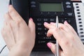 Call center or office phone concept, female finger press number on phonepad Royalty Free Stock Photo