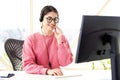 Call center operator businesswoman wearing headset and using computer while working from home Royalty Free Stock Photo