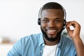 Call Center Operator. Closeup of friendly black man hotline manager in headset Royalty Free Stock Photo