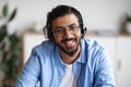 Call Center Operator. Closeup portrait of smiling indian man in headset Royalty Free Stock Photo