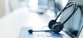 Call center operator desktop. Close-up of a headset on a laptop. Help desk. Workplace of a support service employee Royalty Free Stock Photo