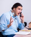 Call center operator working at his desk Royalty Free Stock Photo