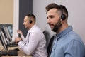 Call center operators with headsets working in modern office Royalty Free Stock Photo