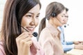 Call center, Service desk consultant talking on hands-free phone, Group of young employee working with a headset. Royalty Free Stock Photo