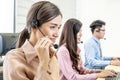 Service desk consultant talking on hands-free phone, Group of young employee working with a headset.