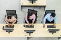 Service desk consultant talking on hands-free phone, Top view of Call Center Operators Working On Computers In Office Royalty Free Stock Photo