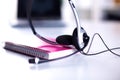 Call center service operator empty working place. Headset, glasses, keyboard and monitor at helpdesk employee workplace Royalty Free Stock Photo